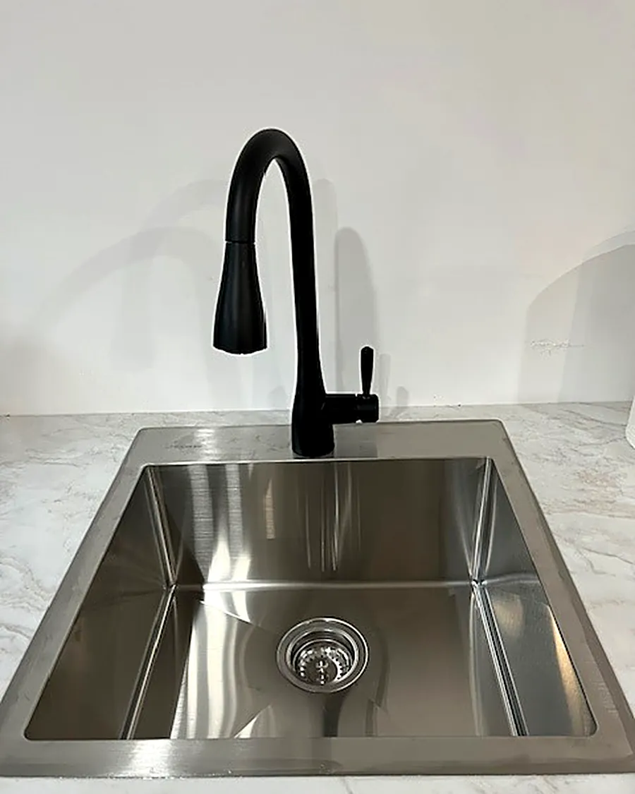 Stainless undermount sink with black pull-down faucet